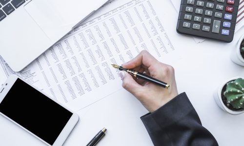 hand-holding-fountain-pen-office-desk